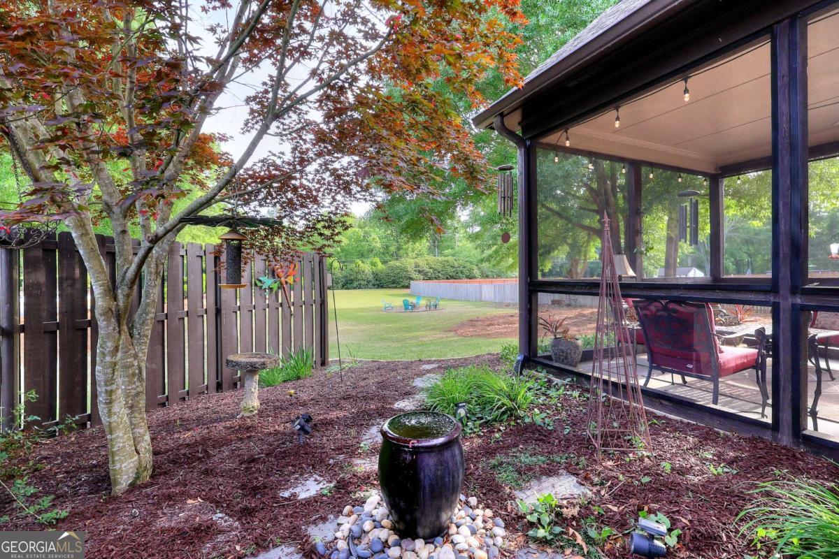 2385 Amberbrook Lane Grayson, GA 30017 - Photo 51 of 57 a view of a patio with a table chairs and a backyard