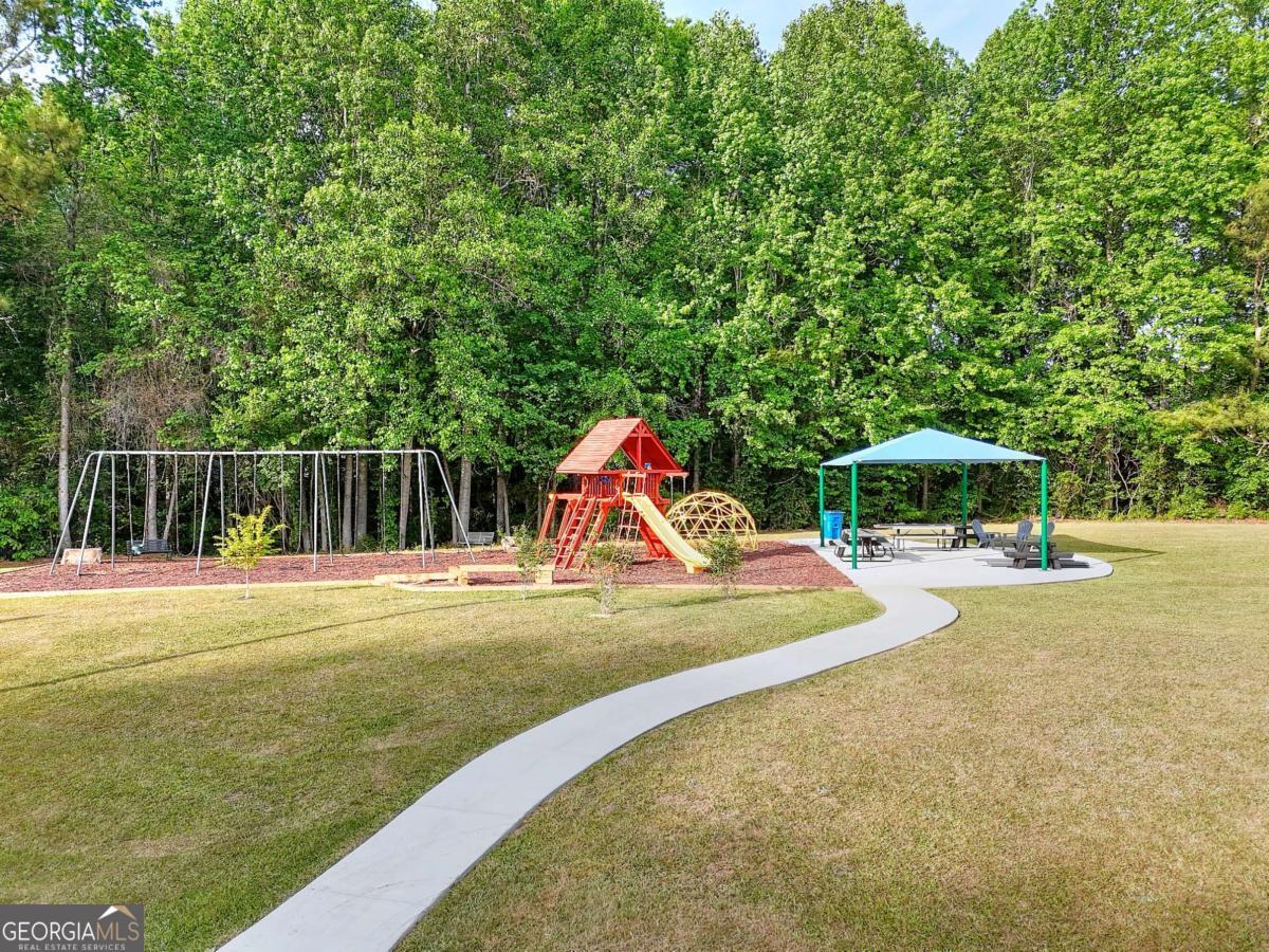 2385 Amberbrook Lane Grayson, GA 30017 - Photo 52 of 57 a view of swimming pool with lawn chairs and plants