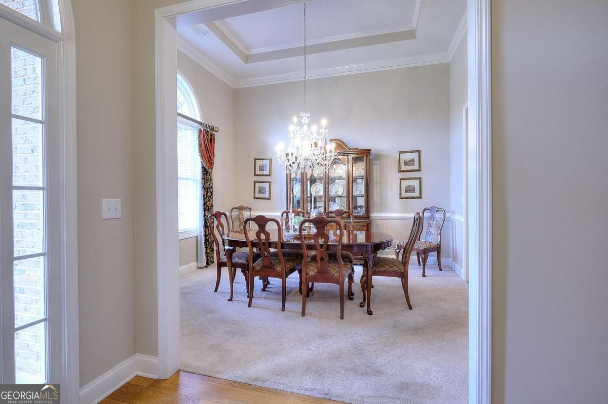 2385 Amberbrook Lane Grayson, GA 30017 - Photo 6 of 57 a view of a dining room with furniture and chandelier