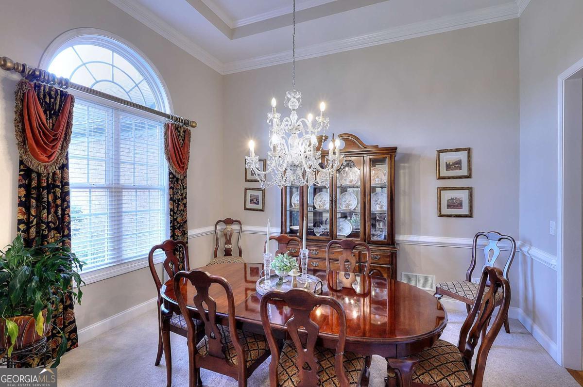 2385 Amberbrook Lane Grayson, GA 30017 - Photo 7 of 57 a view of a dining room with furniture and chandelier