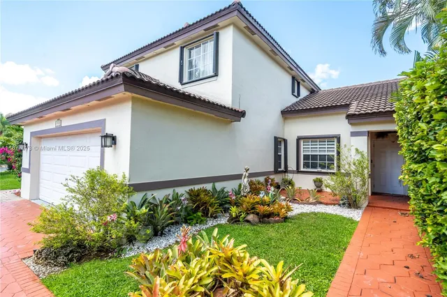 a front view of a house with a yard and outdoor seating