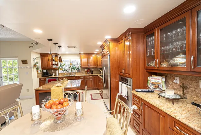 a bathroom with a sink vanity granite toilet and shower