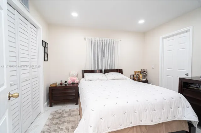 a bedroom with a flat screen tv and a bed