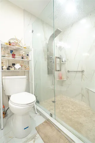 a view of a hallway with wooden floor and windows