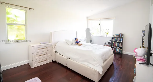 a bedroom with a bed and a mirror