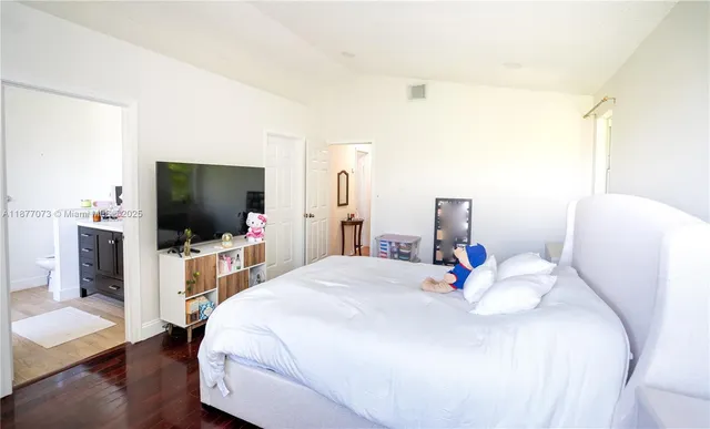 a bedroom with a bed and a flat screen tv
