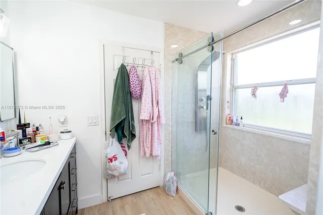 a backyard of a house with chairs and a tree