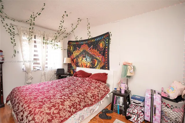 an aerial view of residential houses with outdoor space and lake view