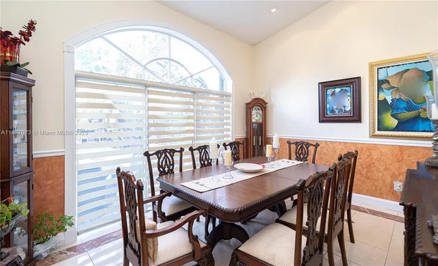 a living room with furniture a rug and a window