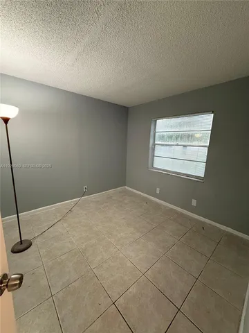 a view of an empty room and a window