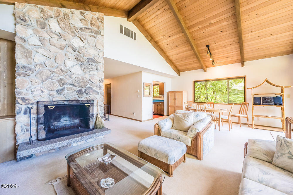 114 Ridge Crest Road Gleneden Beach, OR 97388 - Photo 20 of 40 a living room with furniture and a fireplace
