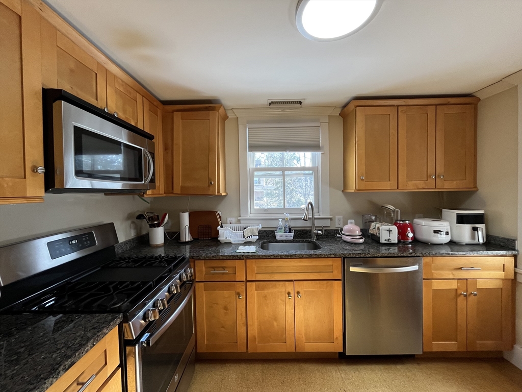 106 Main Street, Unit 2 Andover, MA 01810 - Photo 4 of 11 a kitchen with a sink stove top oven and microwave