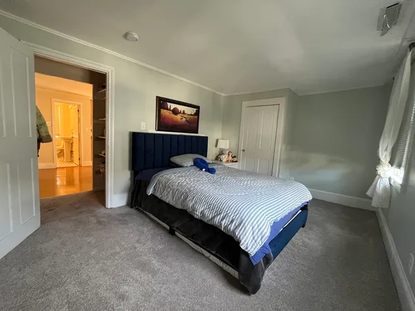 a bedroom with a bed and a night stand