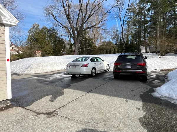 a view of cars parked on the side of a street