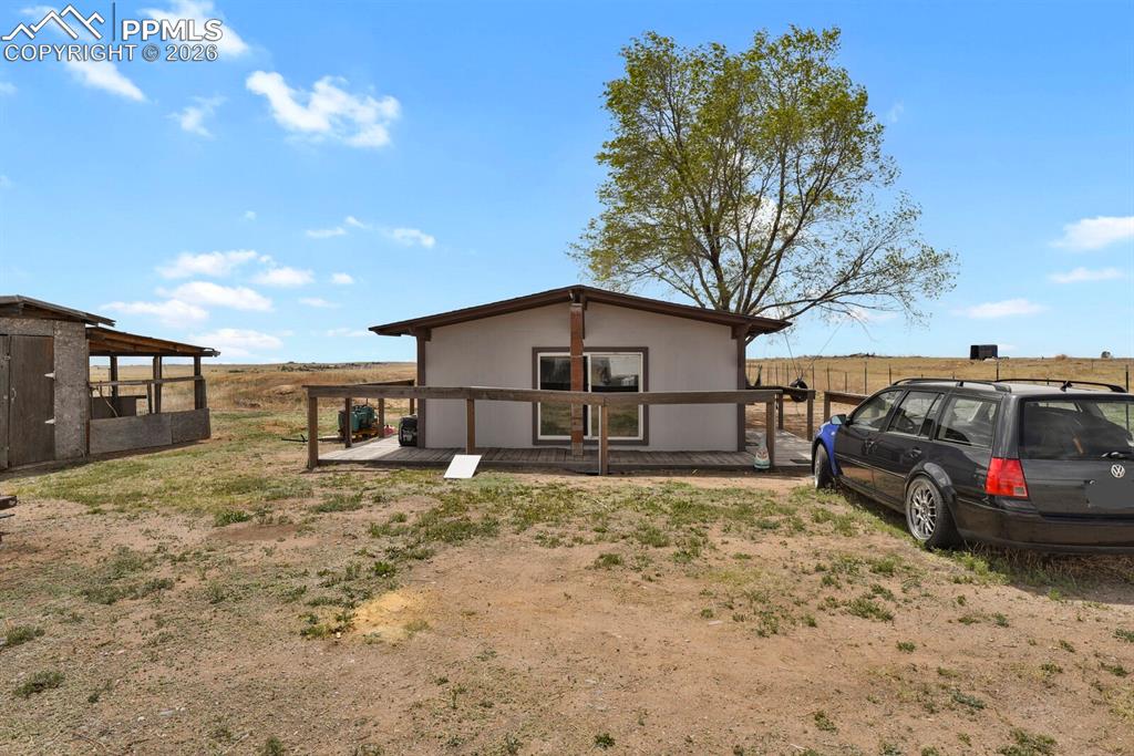 30203 Sanborn Road Yoder, CO 80864 - Photo 14 of 38 a view of a house with a big yard and large tree