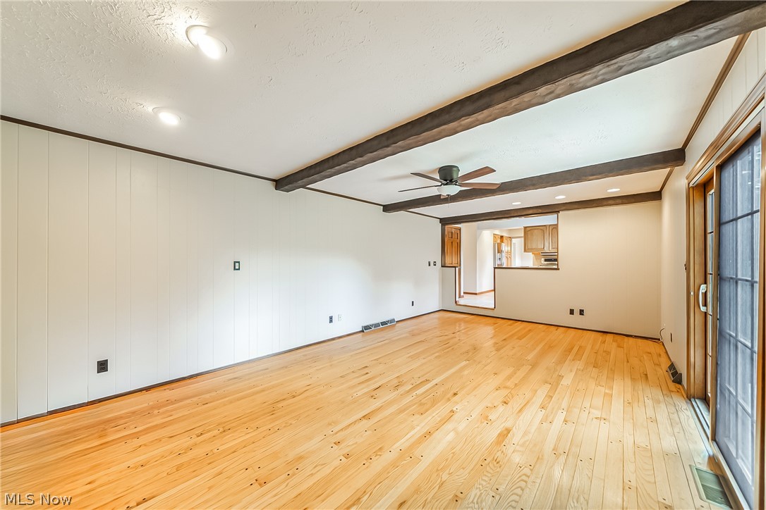 28575 Cannon Road Solon, OH 44139 - Photo 15 of 36 Spare room featuring beamed ceiling, a textured ceiling, light wood-type flooring, and ceiling fan