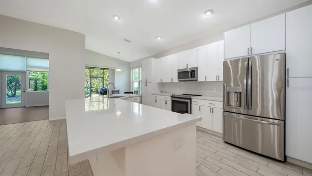 a kitchen with stainless steel appliances a stove top oven a sink and dishwasher