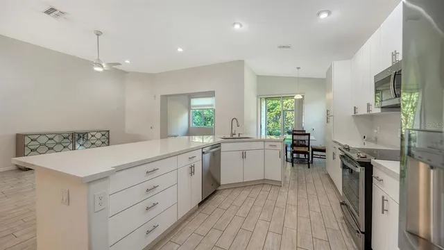 a kitchen with a table chairs sink and cabinets