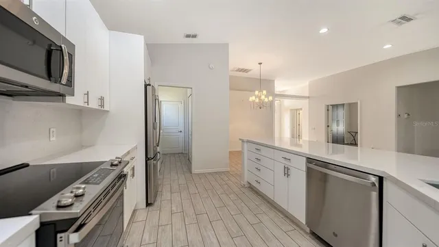 a bedroom with a bed and a potted plant