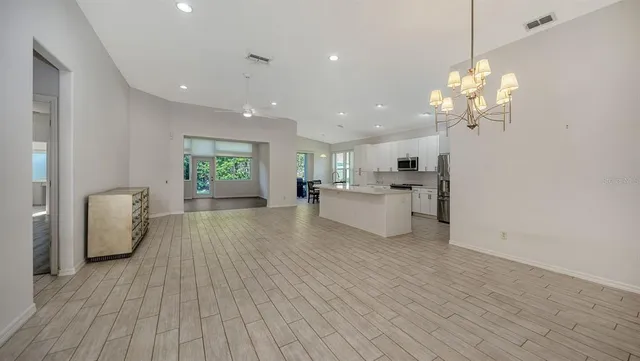 a living room with furniture dining table and wooden floor