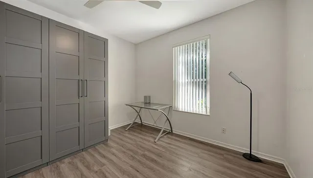 a view of a roof deck with wooden fence and floor