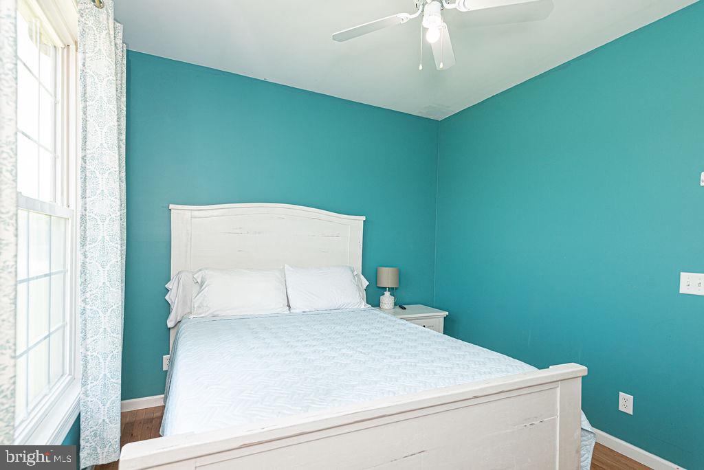 10671 Cathell Road Berlin, MD 21811 - Photo 32 of 63 a bedroom with a bed and a chandelier