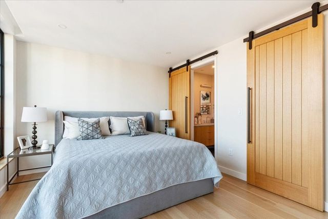 a bedroom with a large bed and a large mirror