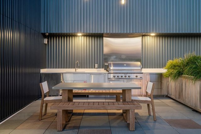 a dinning table and chairs with potted plants