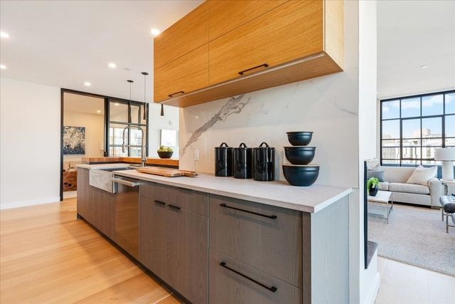a kitchen with stainless steel appliances a sink a stove and a refrigerator