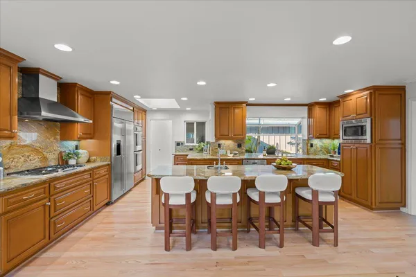 a kitchen with stainless steel appliances granite countertop a sink and cabinets