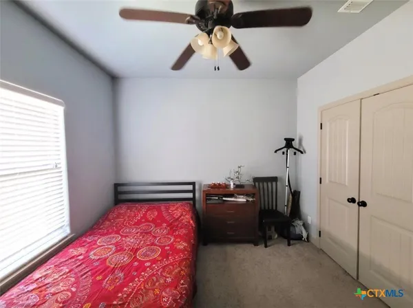 a bathroom with a granite countertop sink toilet and mirror