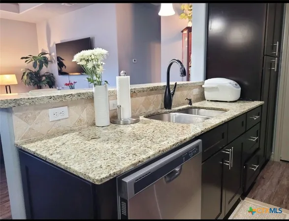 a kitchen with stainless steel appliances granite countertop a refrigerator stove and microwave