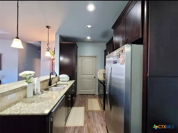 a bedroom with a bed table and chair