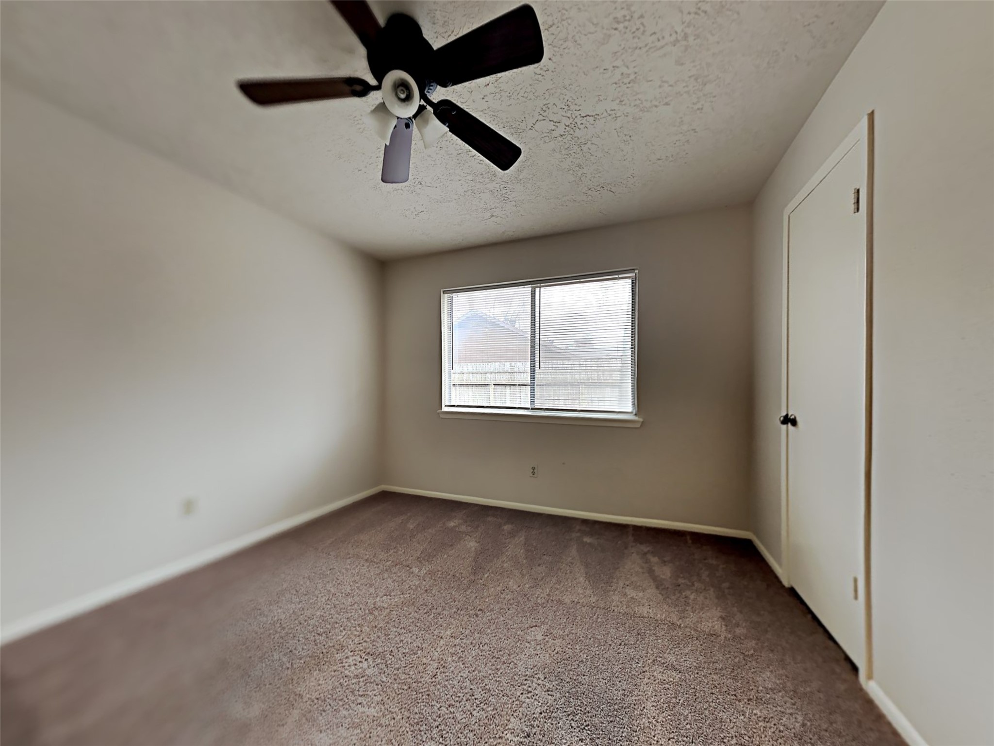 603 Blue Ridge Drive Shenandoah, TX 77381 - Photo 5 of 17 an empty room with a ceiling fan and carpet