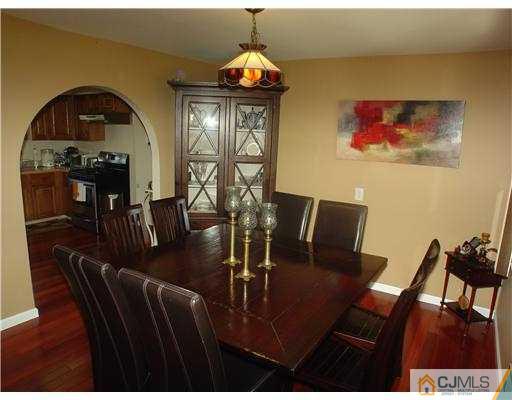 17 Sinclair Road Edison, NJ 08820 - Photo 4 of 11 a view of a dining room with furniture wooden floor and chandelier