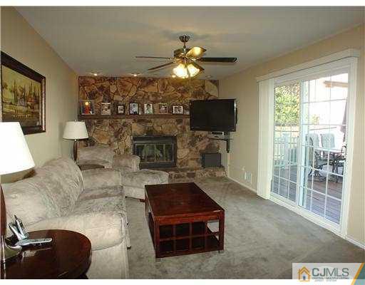 17 Sinclair Road Edison, NJ 08820 - Photo 5 of 11 a living room with furniture a flat screen tv and a fireplace