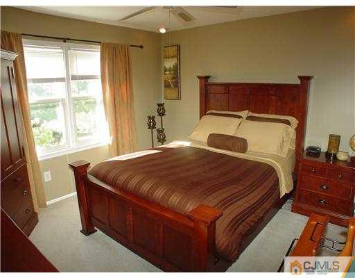 17 Sinclair Road Edison, NJ 08820 - Photo 8 of 11 a bedroom with a bed and wooden floor