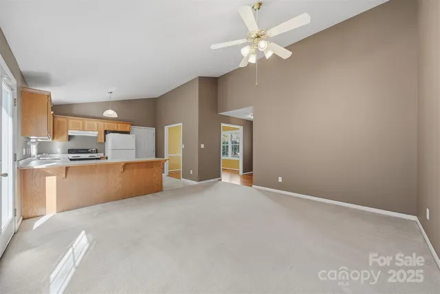 a view of kitchen with windows and ceiling fan