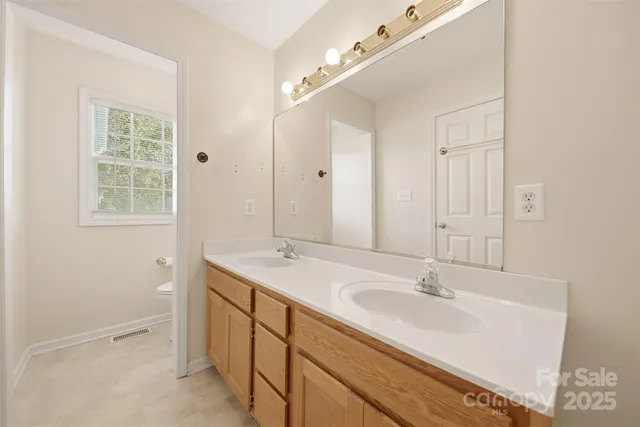 a bathroom with a sink double vanity and a mirror