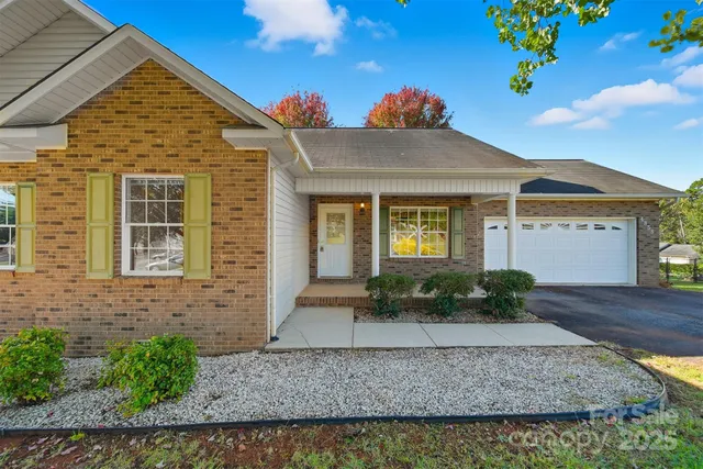 a view of a brick house with large windows