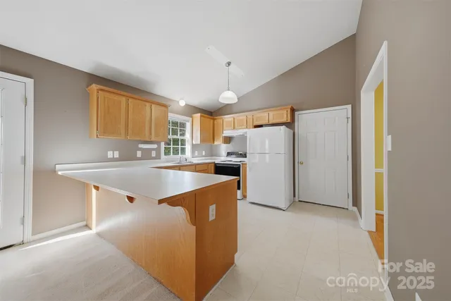 a kitchen with refrigerator a sink and cabinets