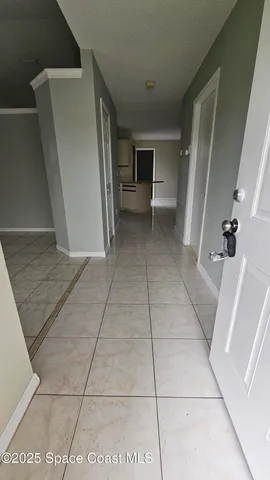 a view of an empty room and a bathroom