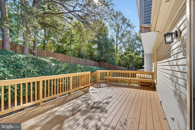 a view of balcony with wooden floor and fence