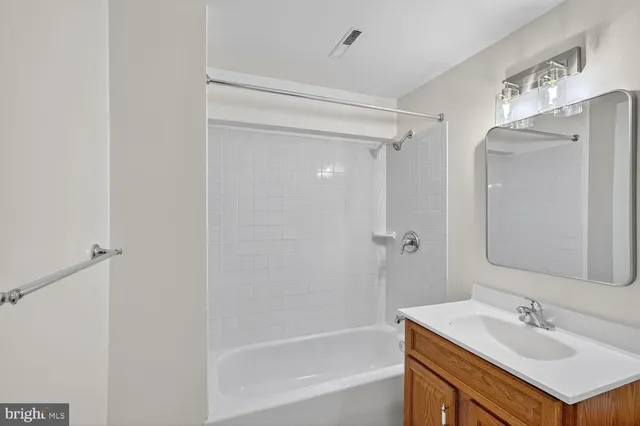 a bathroom with a sink mirror toilet and bathtub
