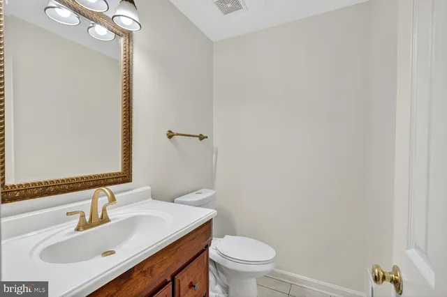 a bathroom with a sink toilet and a mirror