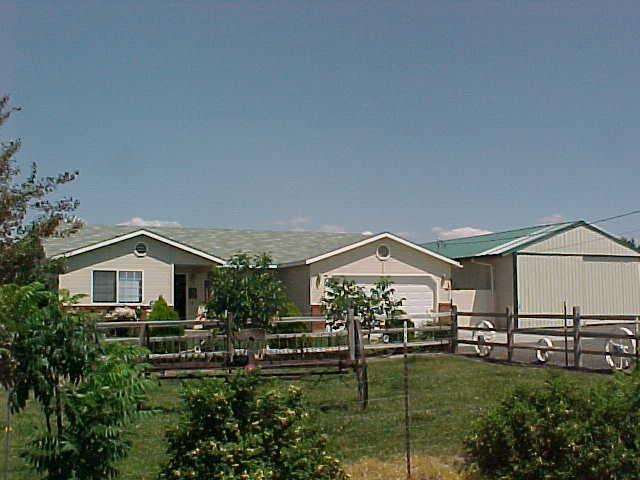 491 East Duffield Road Moxee, WA 98936 - Photo 5 of 9 a view of house with garden and tall trees