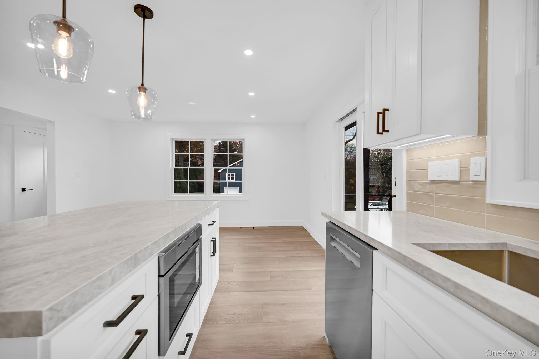 82 Seton Drive New Rochelle, NY 10804 - Photo 18 of 50 a kitchen with stainless steel appliances granite countertop a sink a oven and a large window