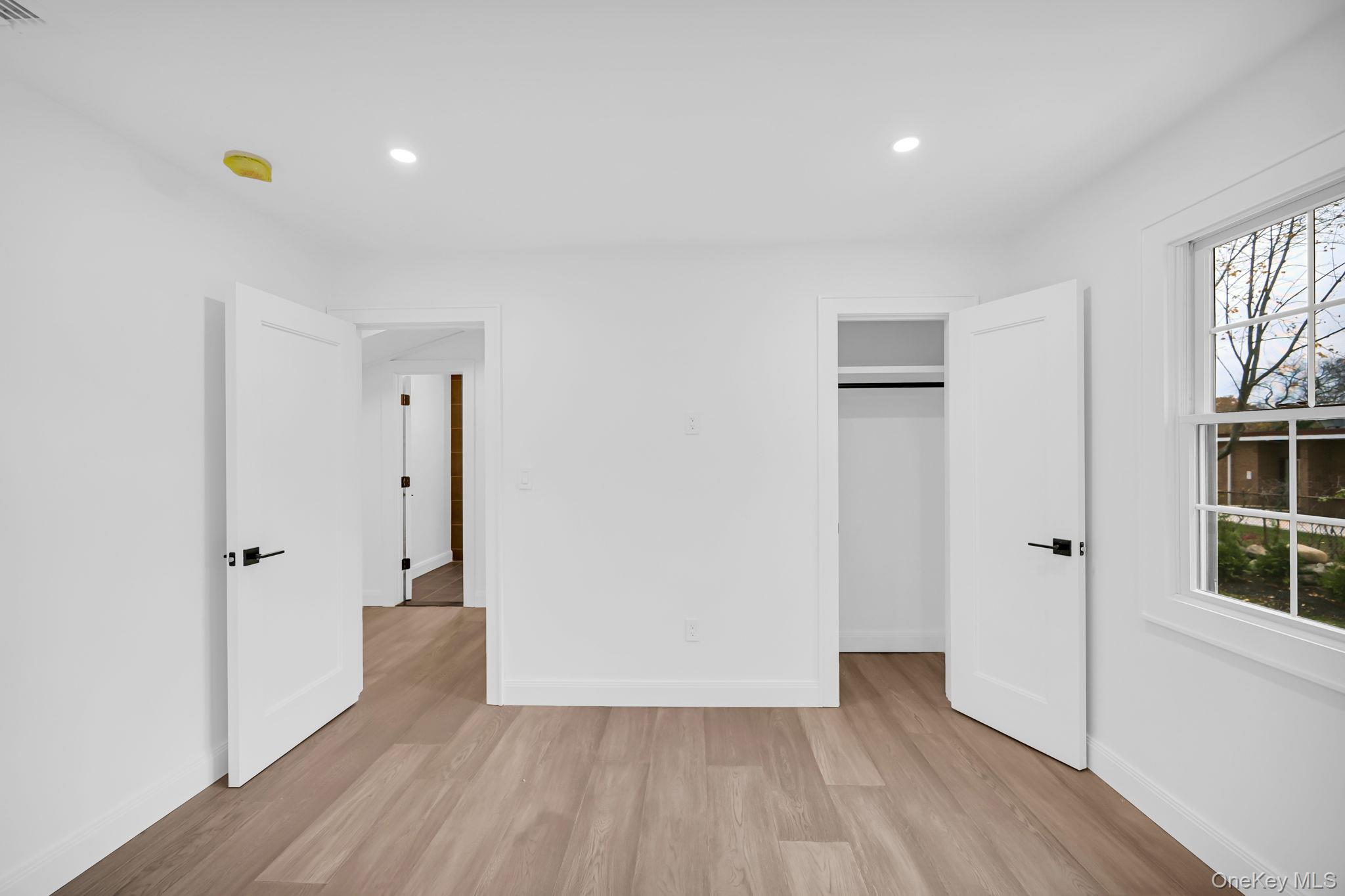 82 Seton Drive New Rochelle, NY 10804 - Photo 24 of 50 a view of an empty room with wooden floor and closet