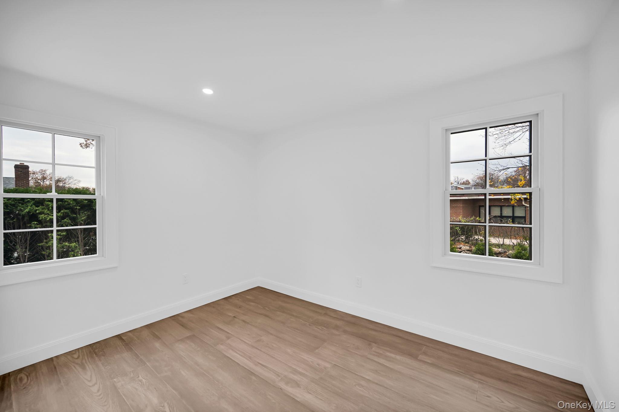 82 Seton Drive New Rochelle, NY 10804 - Photo 25 of 50 an empty room with wooden floor and windows