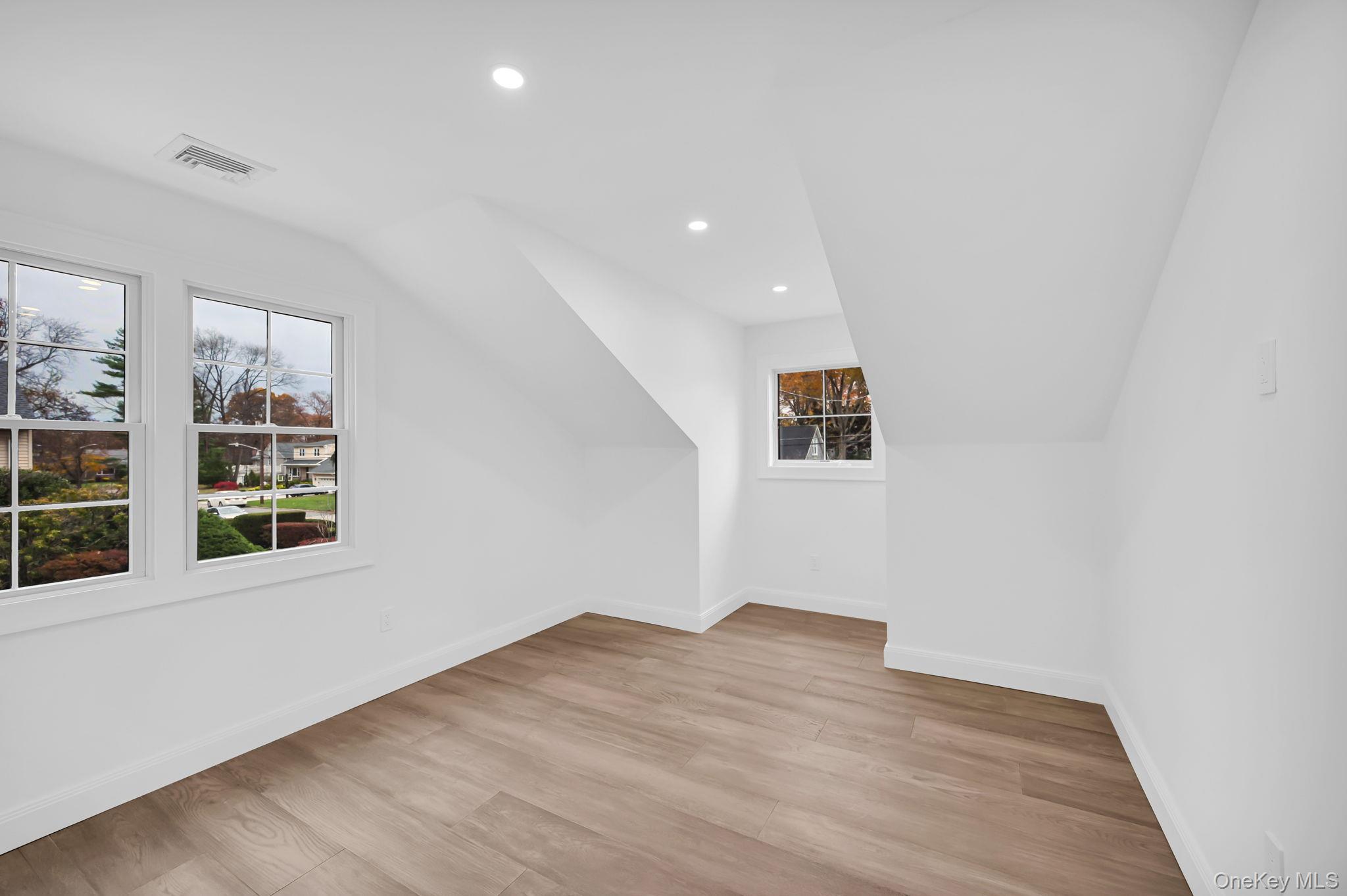 82 Seton Drive New Rochelle, NY 10804 - Photo 27 of 50 an empty room with wooden floor and windows